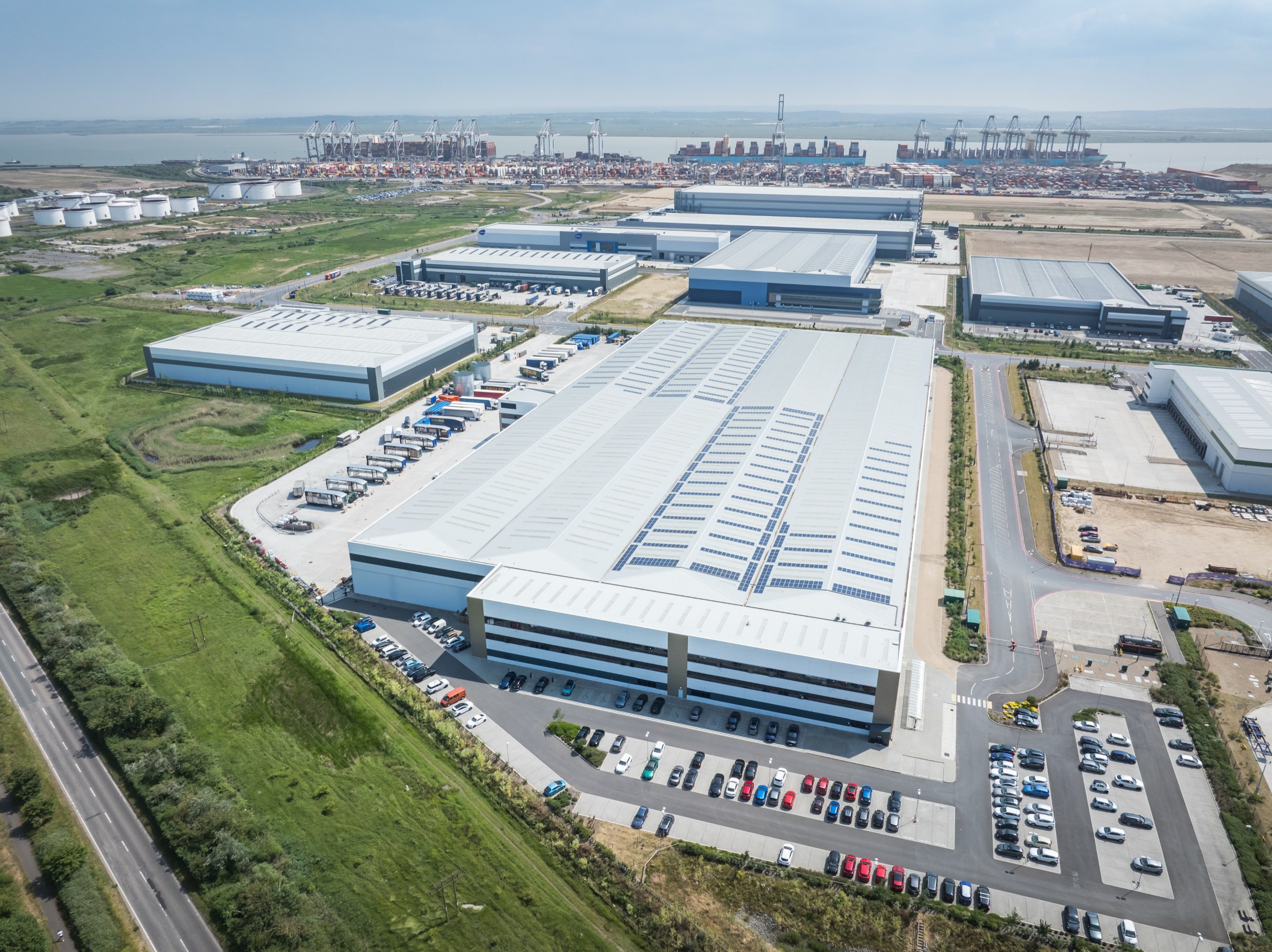 Aerial view of a logistics unit at DP World London Gateway with the deep-sea port beyond